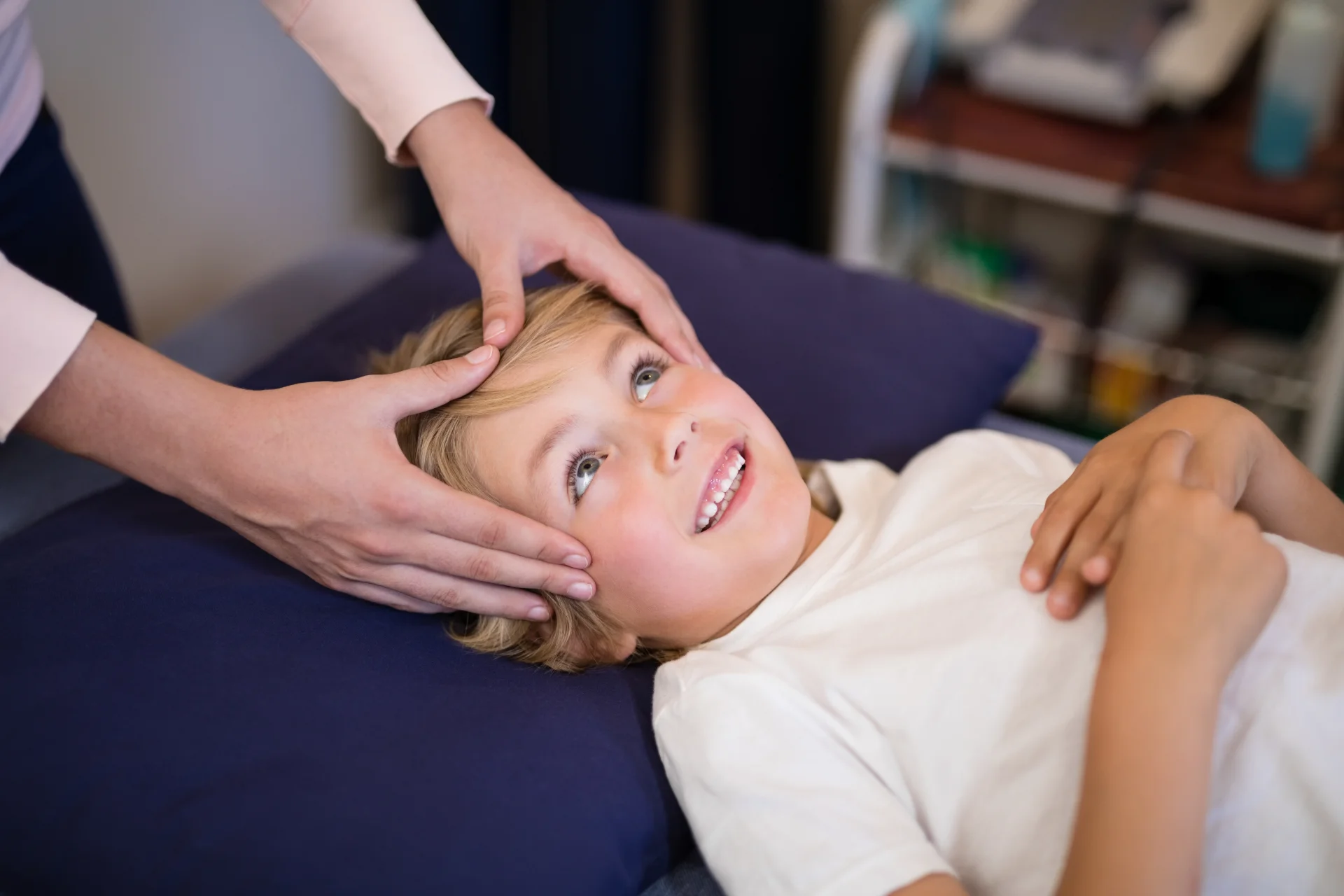 child receiving gentle head massage on therapy tab 2026 03 25 01 33 10 utc
